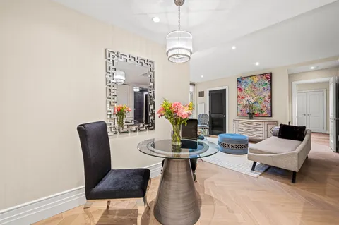 a dining room with furniture and wooden floor