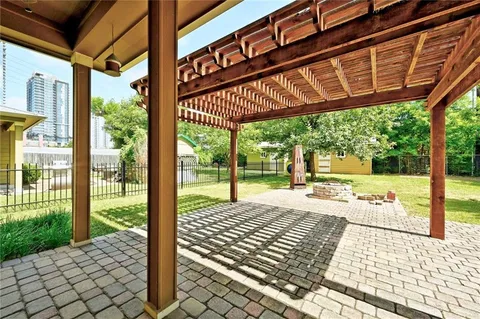 a view of a porch with wooden floor and fence