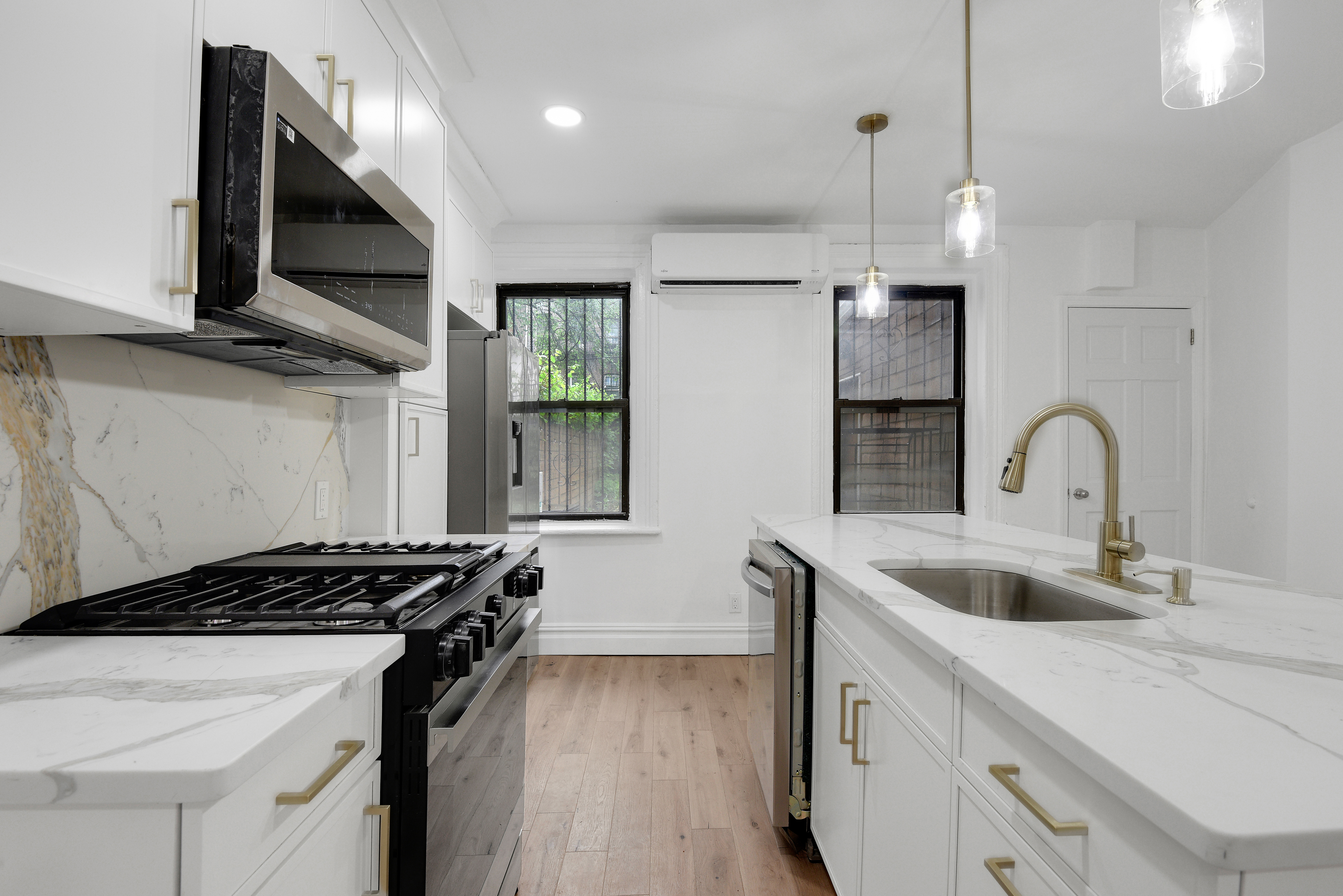 a kitchen with kitchen island stainless steel appliances a sink stove and refrigerator