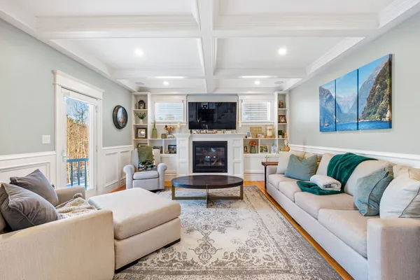 a living room with furniture fireplace and flat screen tv