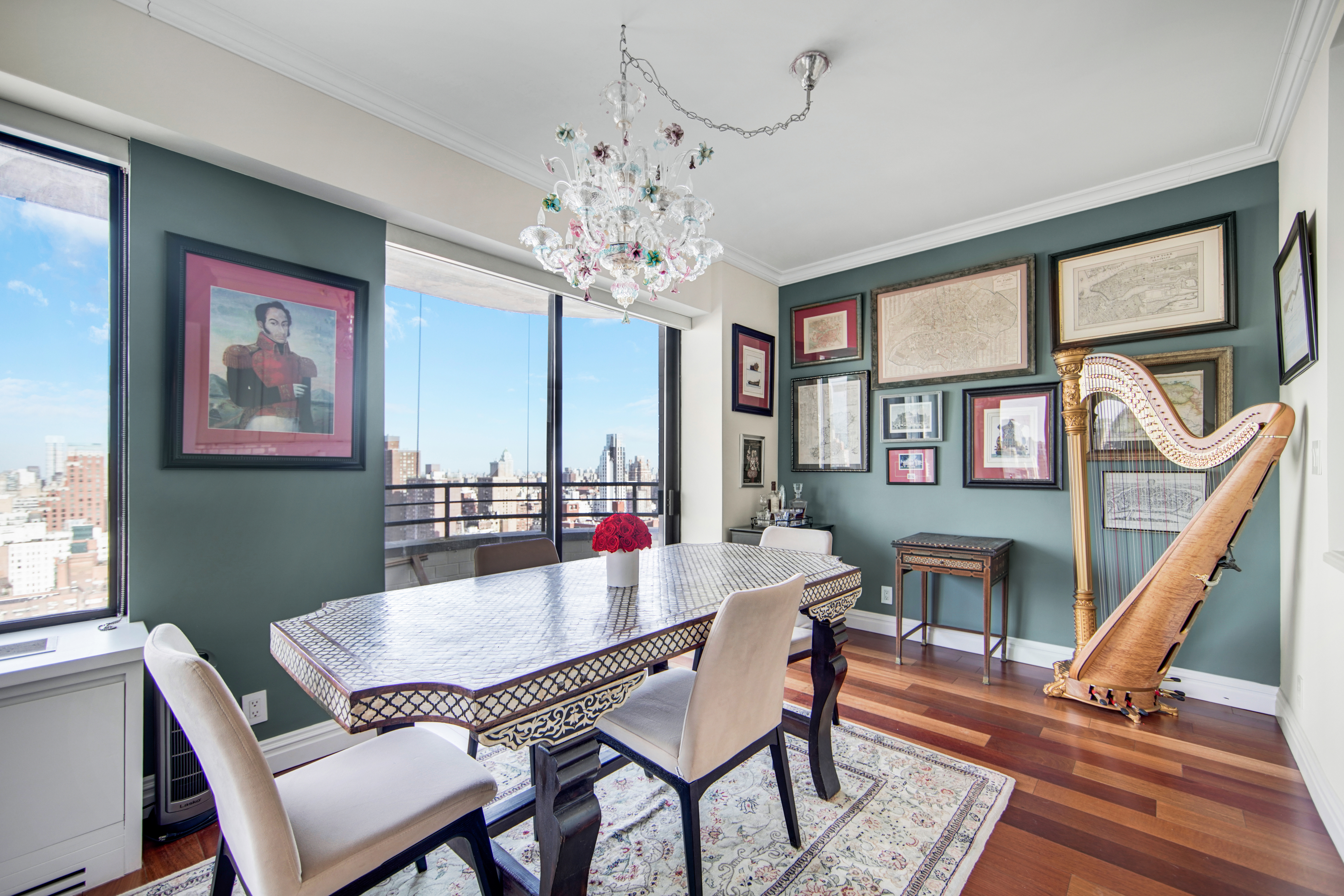 400 East 70th Street, Unit 3301 Manhattan, NY 10021 - Photo 4 of 20 a dining room with furniture a chandelier and wooden floor