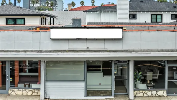 a view of a building with a window and refrigerator