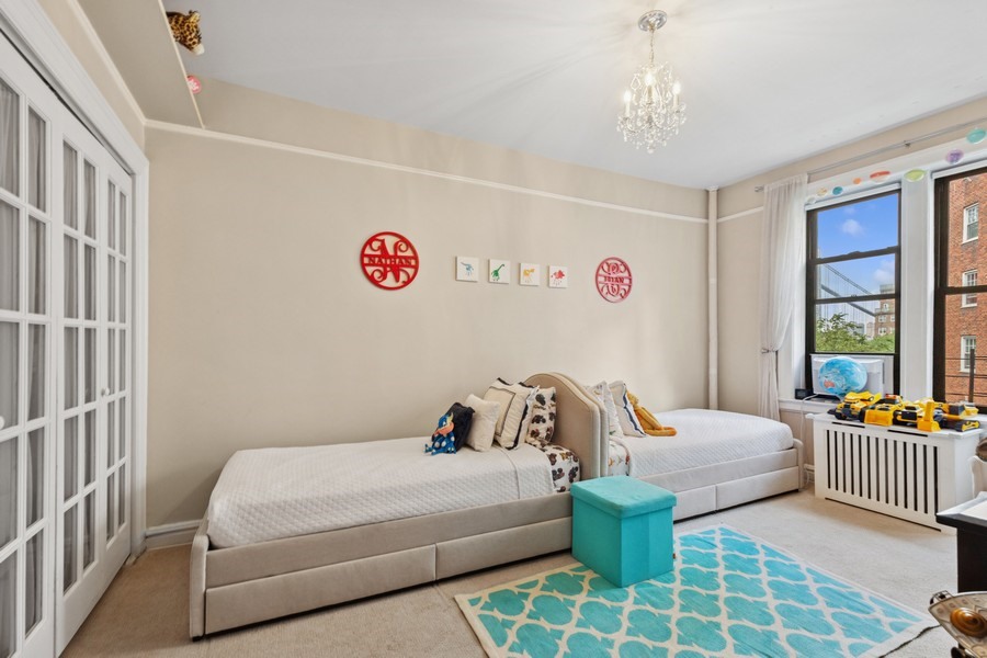 125 Cabrini Boulevard, Unit A52 Manhattan, NY 10033 - Photo 12 of 20 a bedroom with three beds and a window