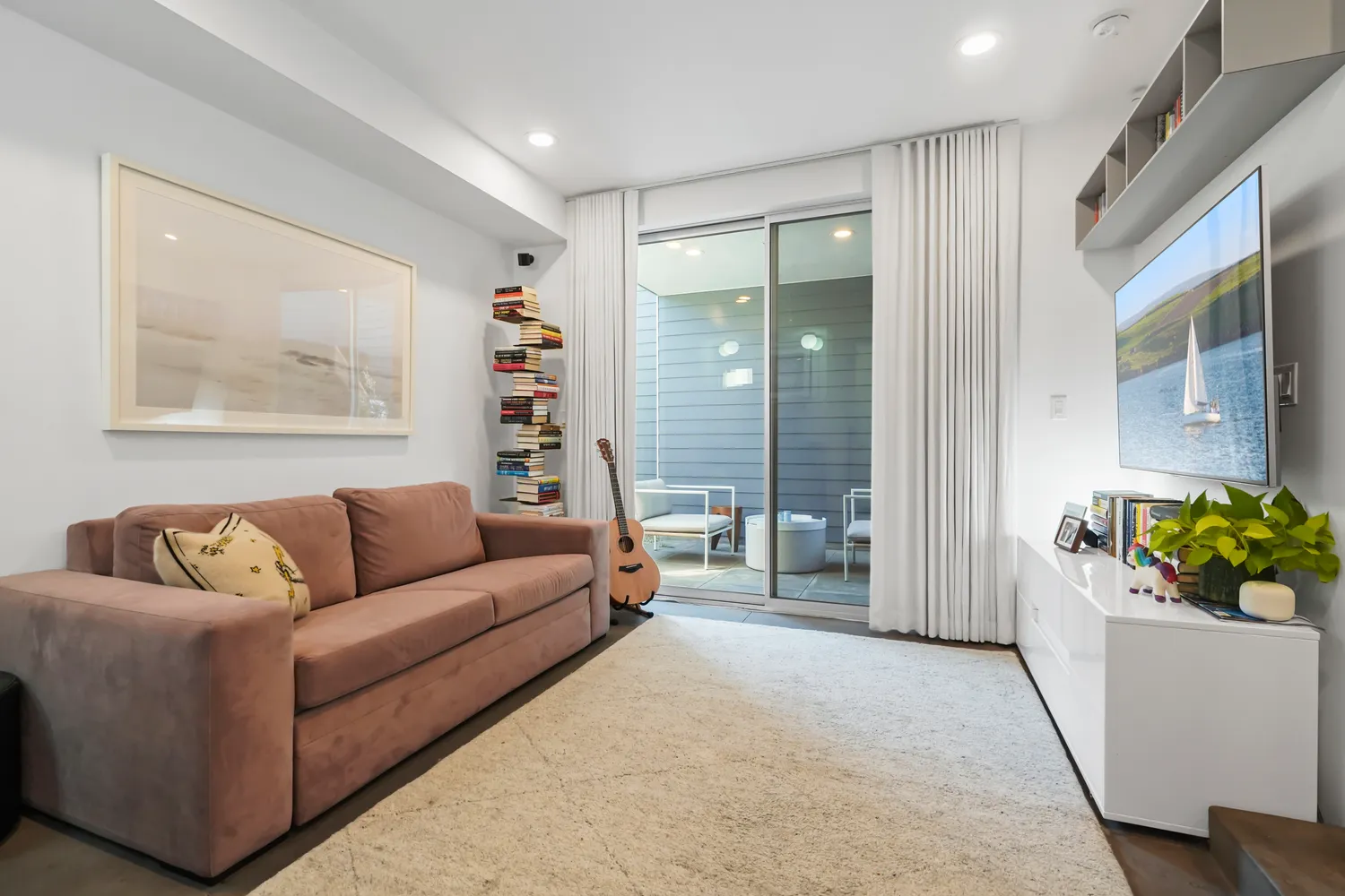 a living room with furniture and a potted plant