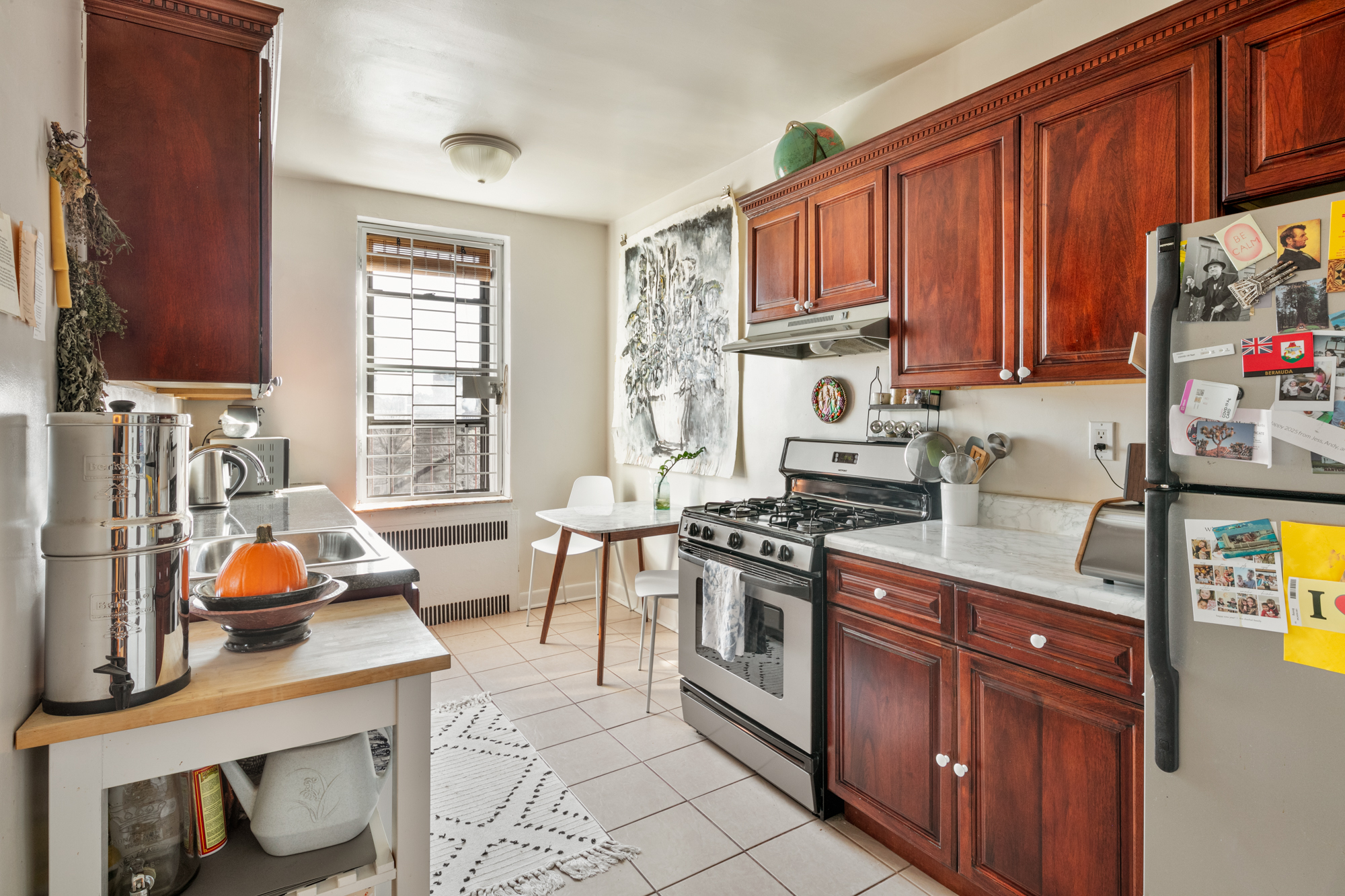 960 Sterling Place, Unit 5K Brooklyn, NY 11213 - Photo 4 of 7 a kitchen with stainless steel appliances wooden cabinets and a stove top oven