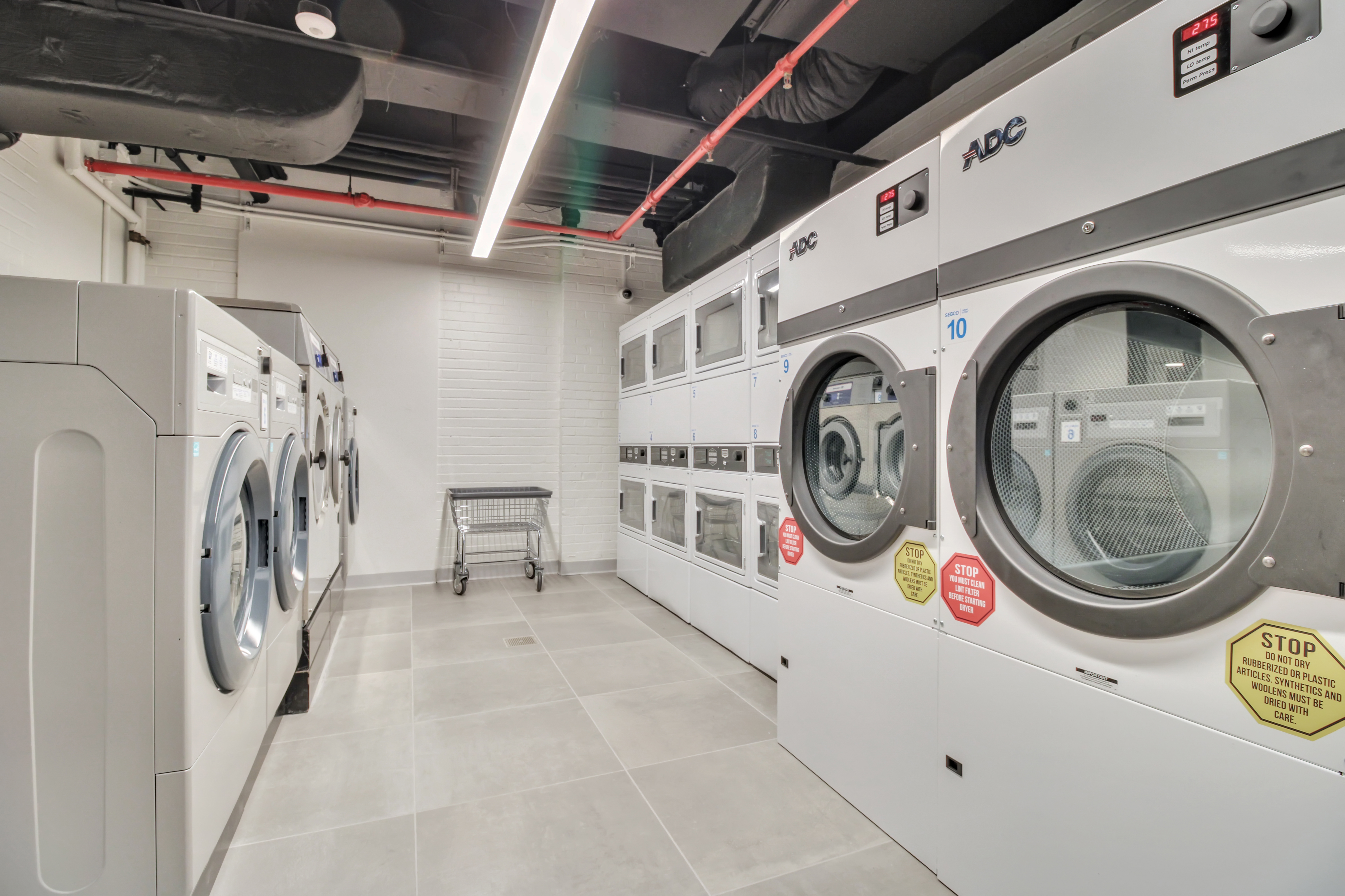 56 7th Avenue, Unit 3G Manhattan, NY 10011 - Photo 9 of 10 a utility room with dryer and washer