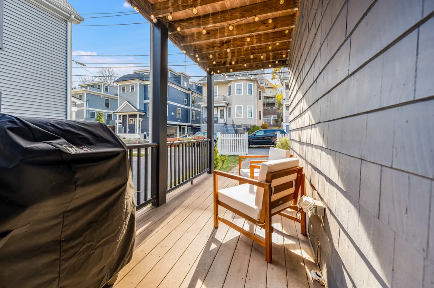 a view of a balcony with chairs and wooden floor