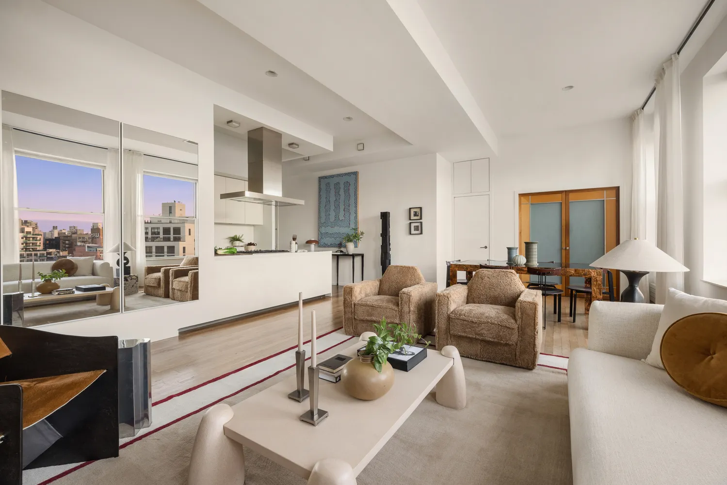 a living room with furniture and a dining table with kitchen view