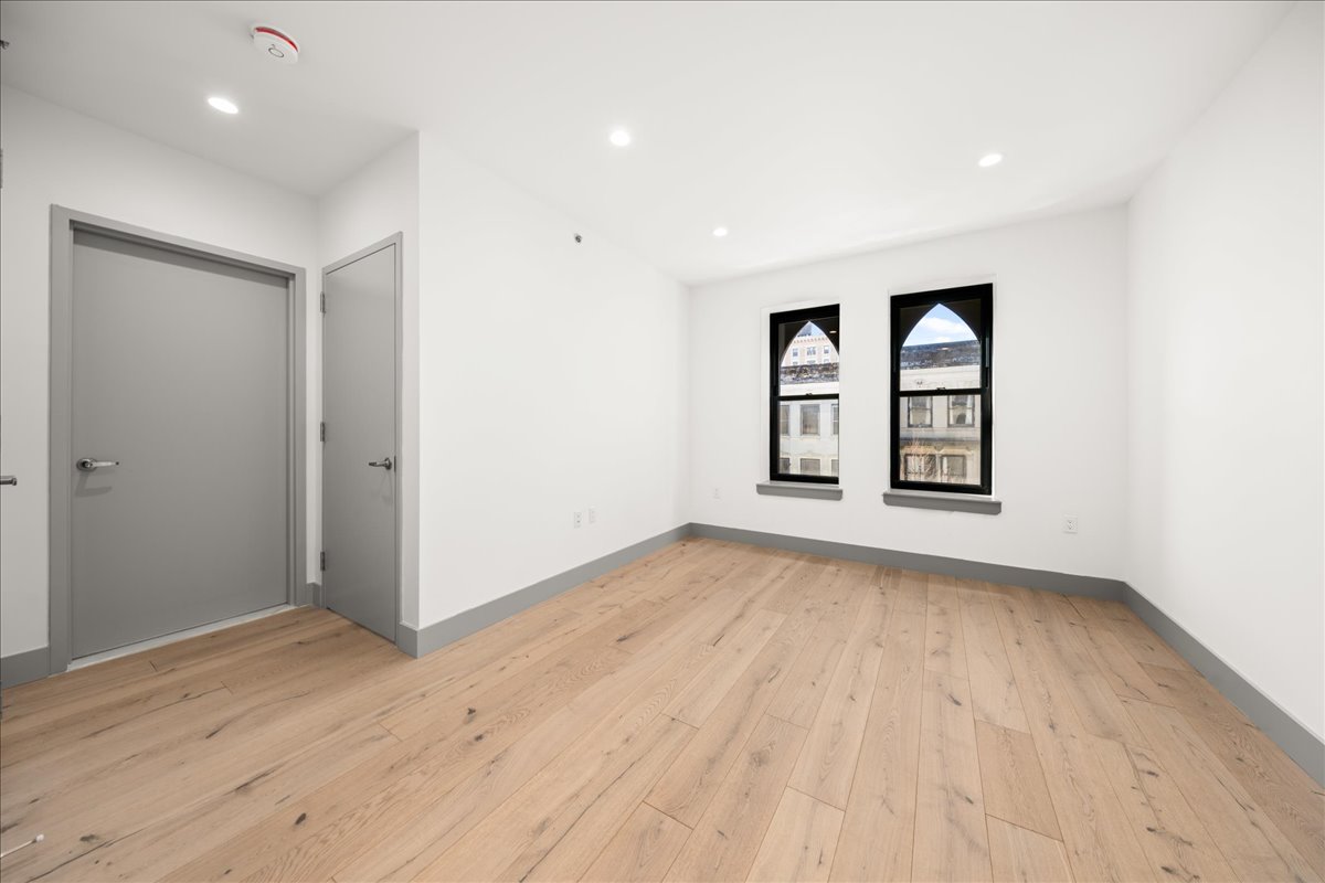 463 West 142nd Street, Unit 4B Manhattan, NY 10031 - Photo 1 of 10 wooden floor in an empty room with a window