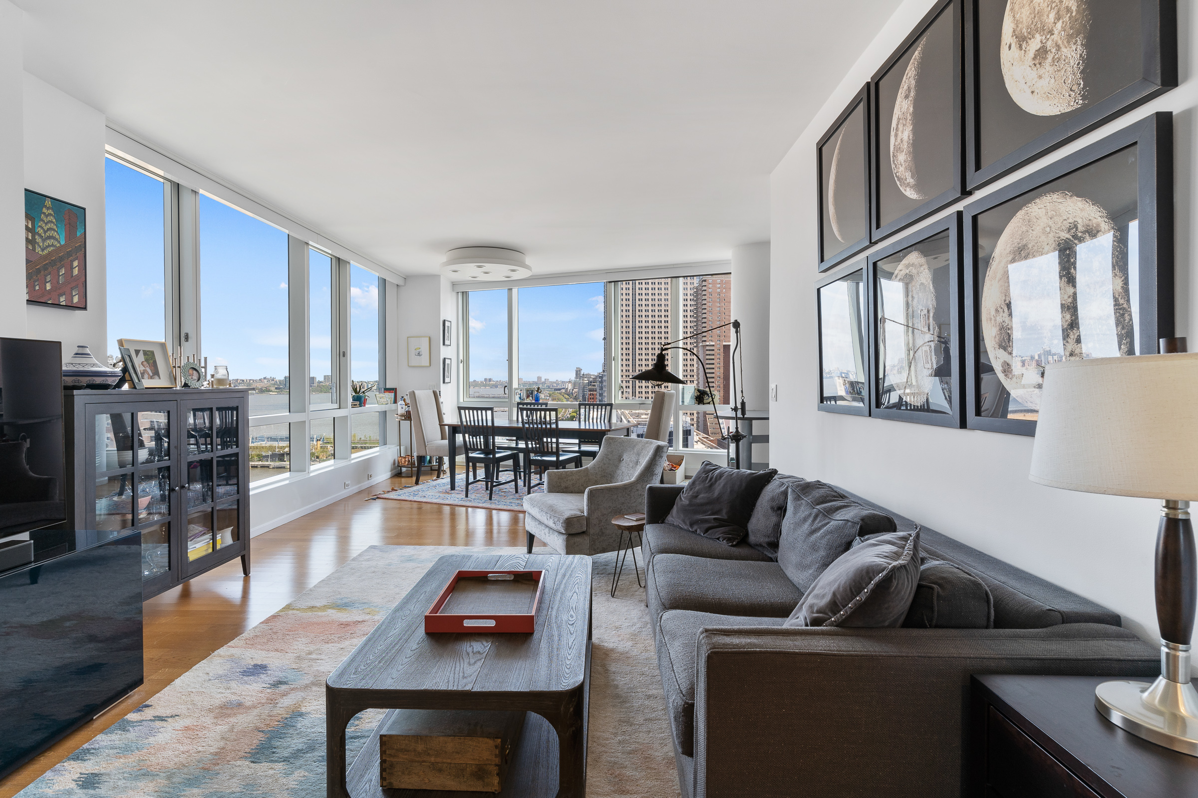 200 Chambers Street, Unit 16D Manhattan, NY 10007 - Photo 1 of 12 a living room with furniture and a flat screen tv