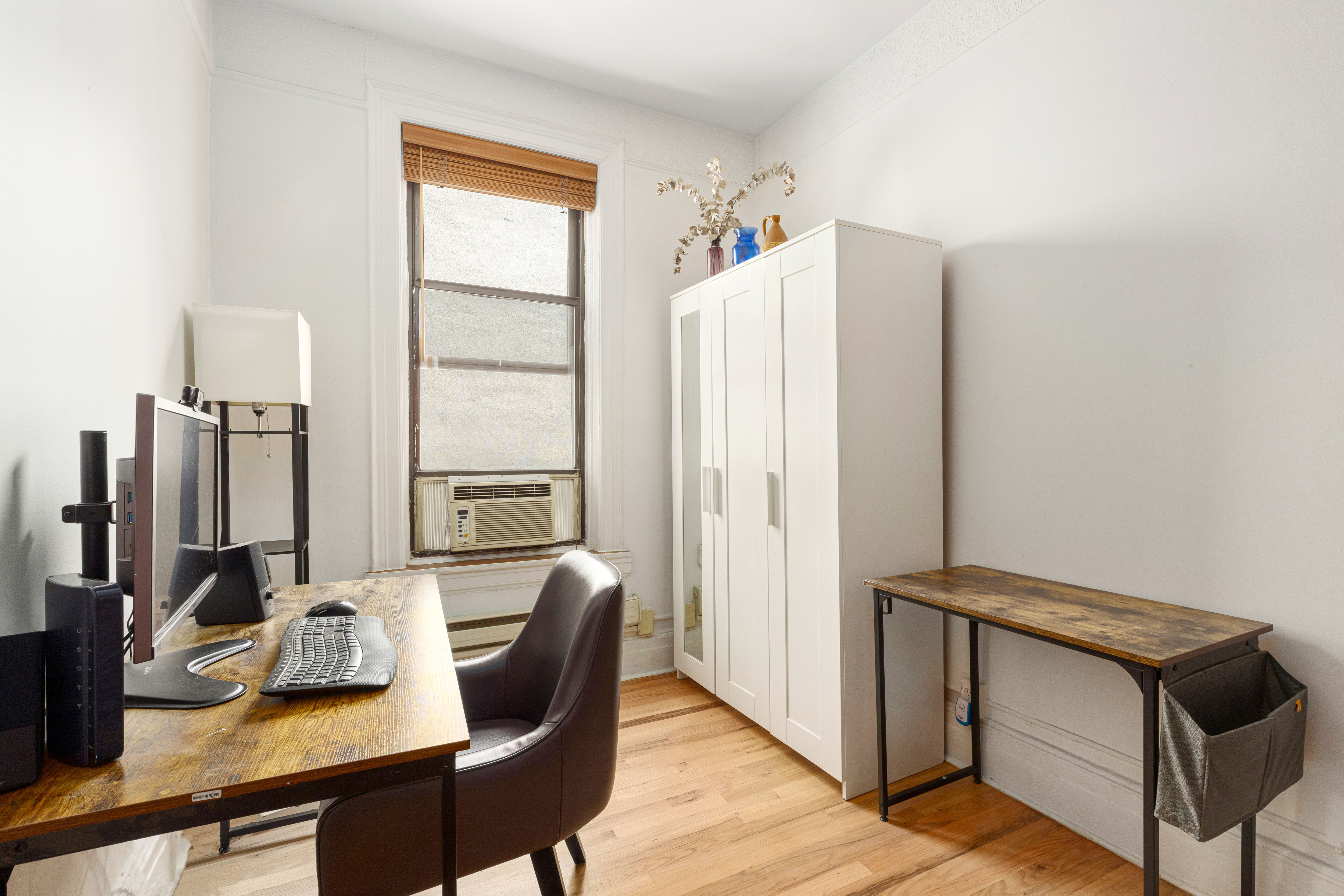 199 Prince Street, Unit 17 Manhattan, NY 10012 - Photo 4 of 6 a view of a workspace with furniture and a window