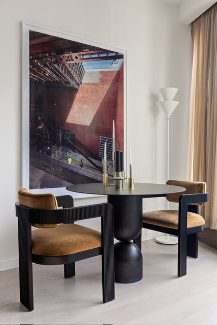500 West 18th Street, Unit WEST 5E Manhattan, NY 10011 - Photo 7 of 15 a living room with a table and a potted plant