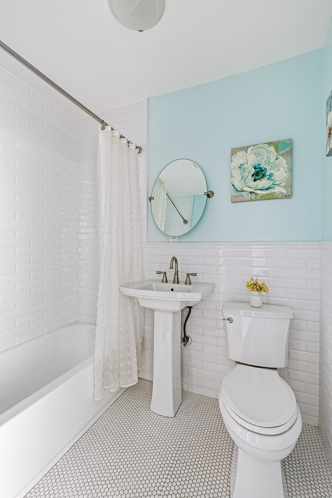 231 Vernon Avenue Brooklyn, NY 11206 - Photo 5 of 13 a bathroom with a sink a toilet a mirror and shower