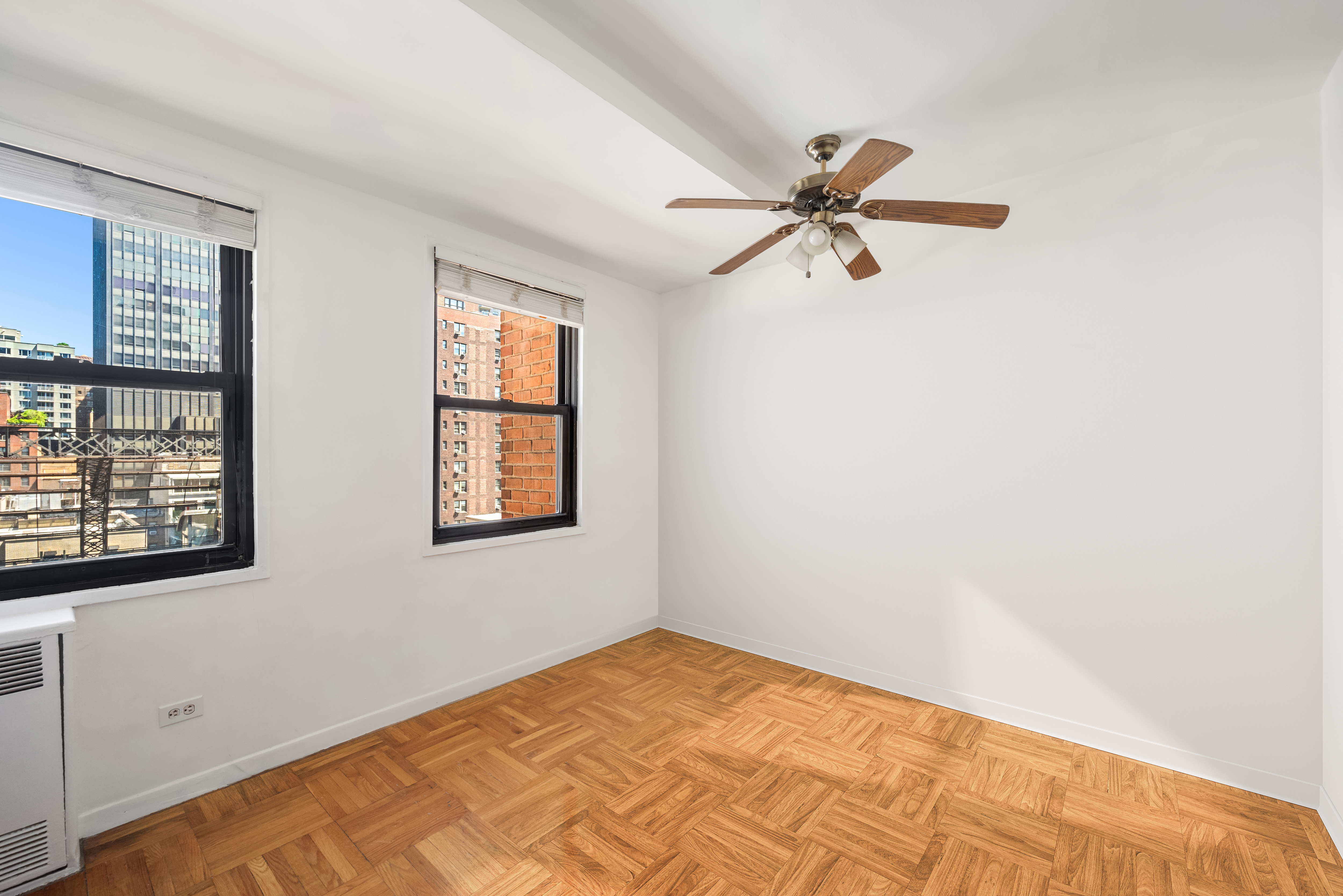 347 East 53rd Street, Unit 9C Manhattan, NY 10022 - Photo 6 of 10 a view of a room with a window and a ceiling fan