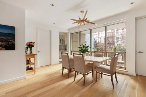 a dining room with furniture window and wooden floor