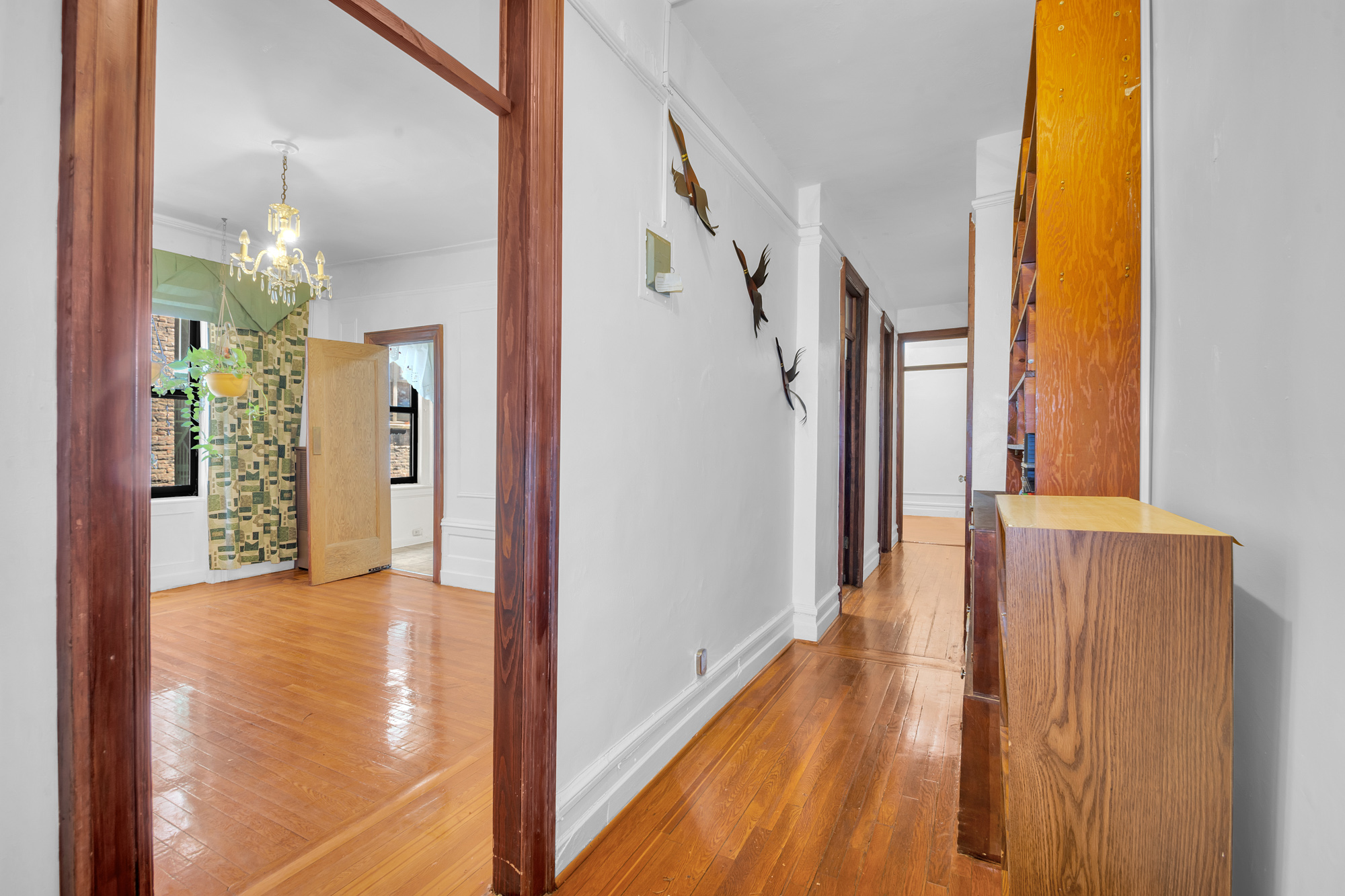 302 Convent Avenue, Unit 43 Manhattan, NY 10031 - Photo 2 of 5 a view of a hallway with wooden floor and a bathroom