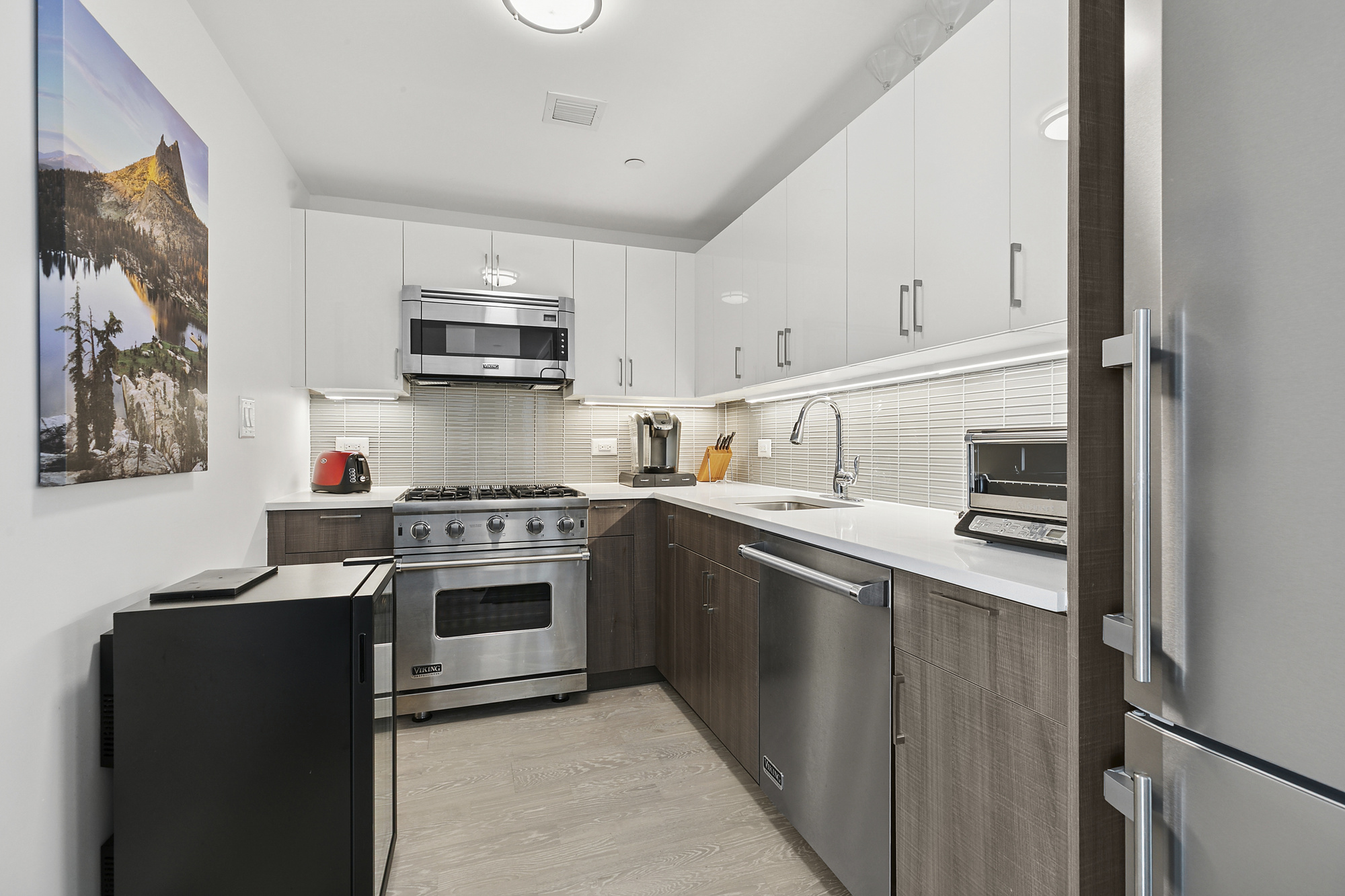 2351 Adam Clayton Powell Jr Boulevard, Unit PH23 Manhattan, NY 10030 - Photo 3 of 9 a kitchen with stainless steel appliances granite countertop a refrigerator and a stove top oven
