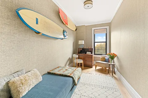 a bed room with a bed and a chair