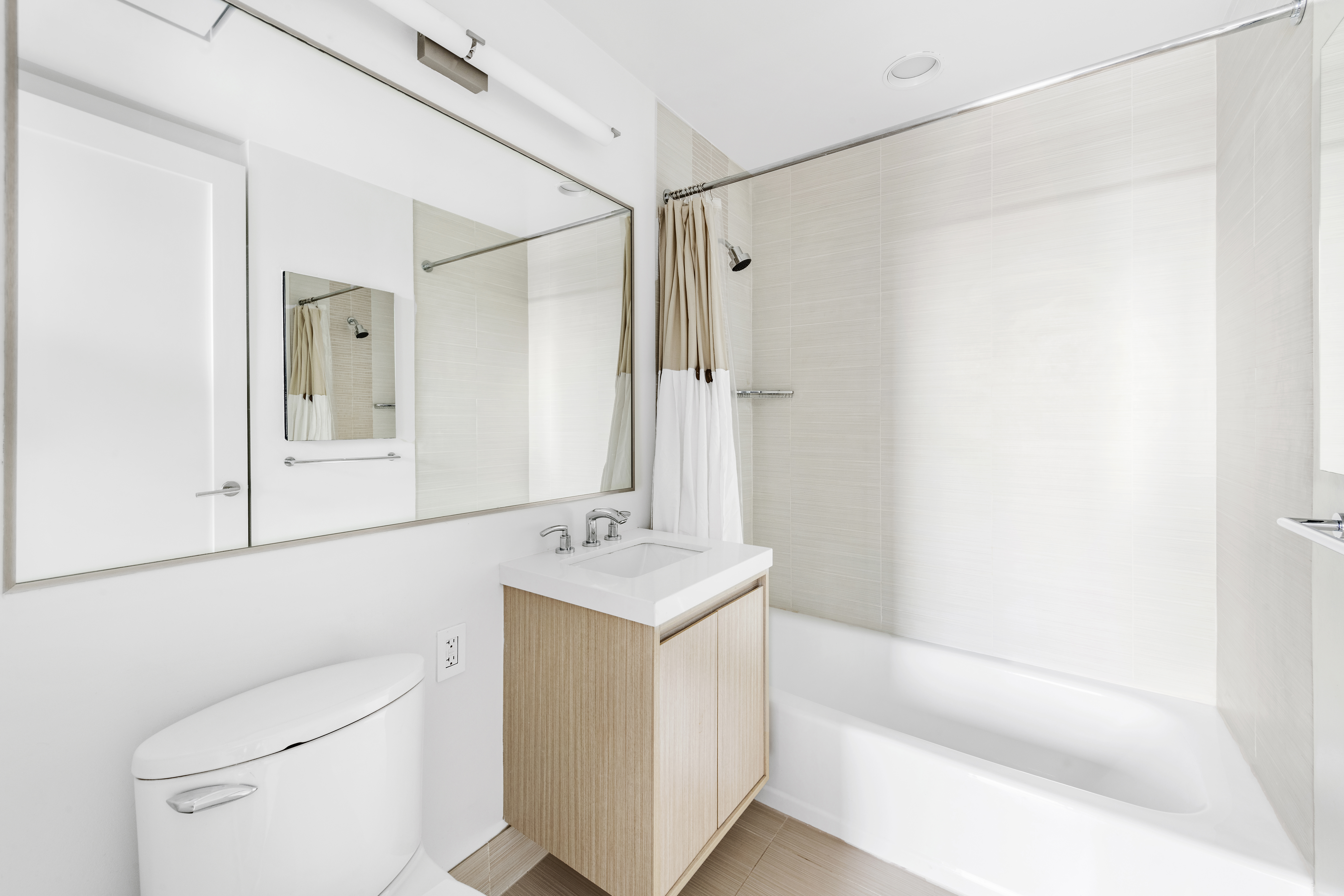 200 West 67th Street, Unit 32C Manhattan, NY 10023 - Photo 6 of 17 a bathroom with a sink a toilet and shower