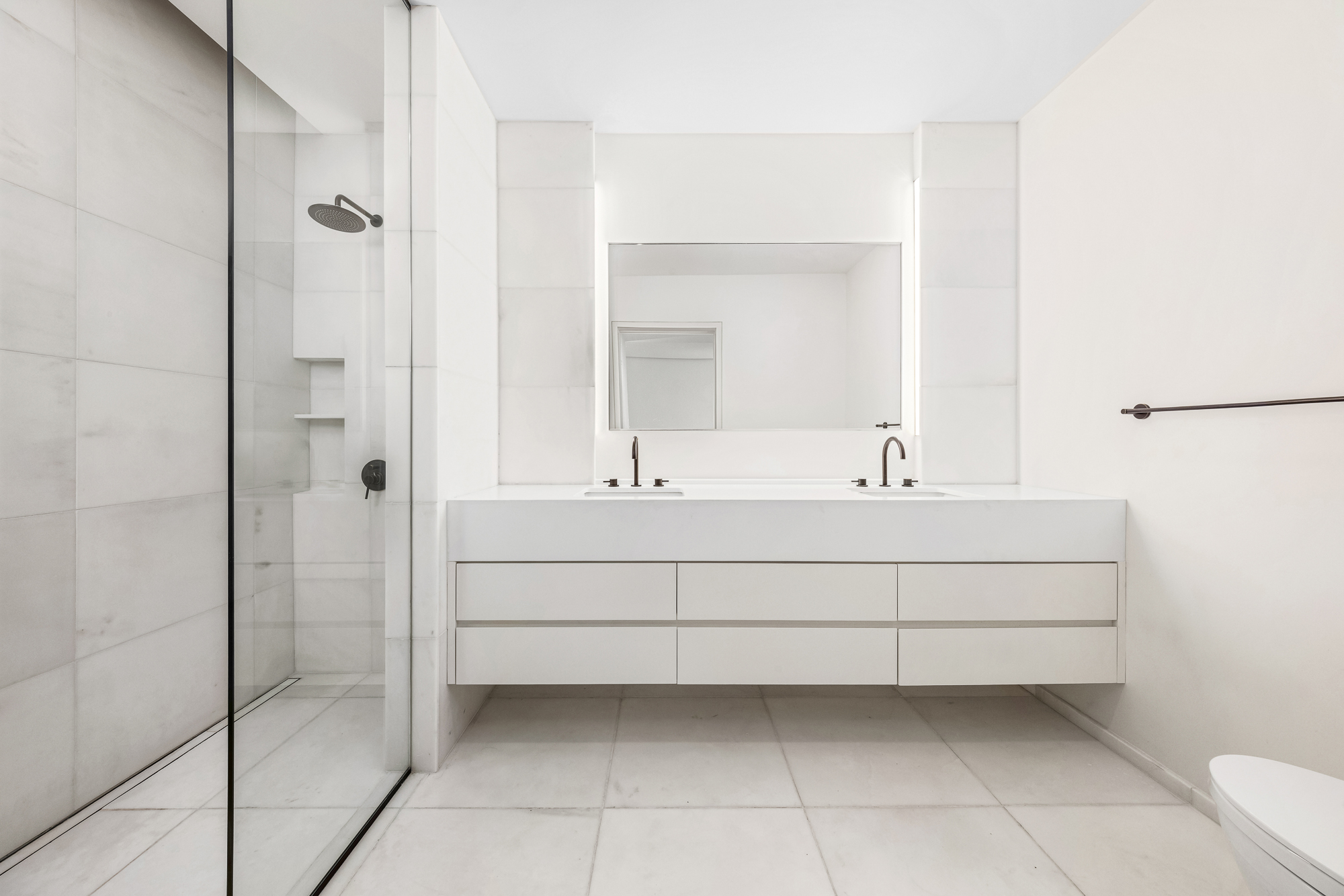 66 Clinton Street, Unit 1A Manhattan, NY 10002 - Photo 8 of 20 a bathroom with a bathtub sink vanity and mirror