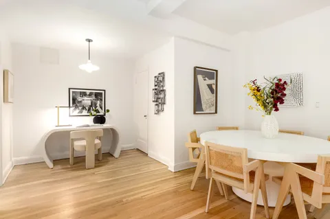 a bedroom with a bed and a table chair