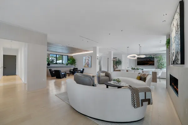 a living room with couches large window and a flat screen tv