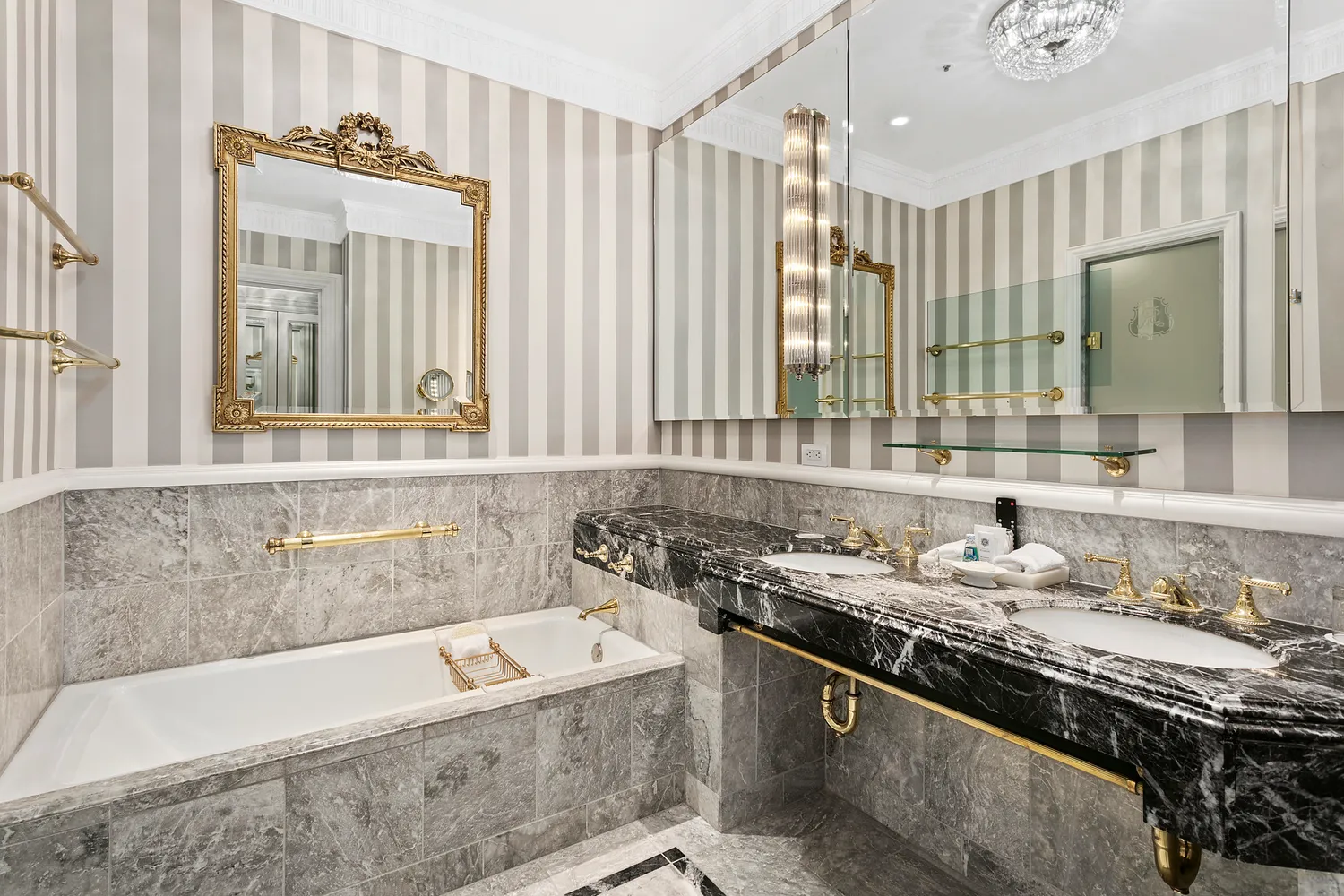 a bathroom with a granite countertop tub sink and mirror