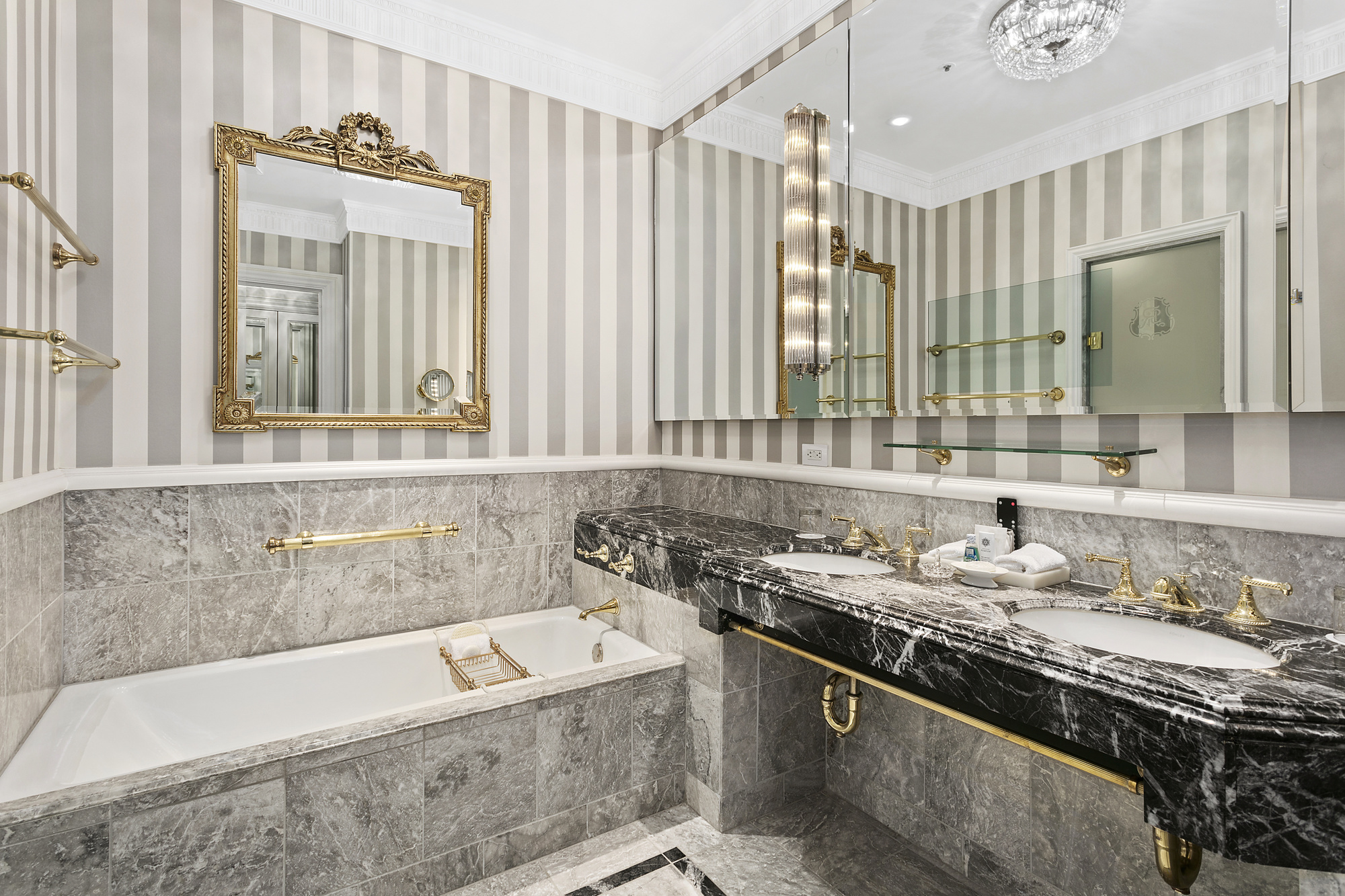 2 East 55th Street, Unit 829W38 Manhattan, NY 10022 - Photo 5 of 13 a bathroom with a granite countertop tub sink and mirror