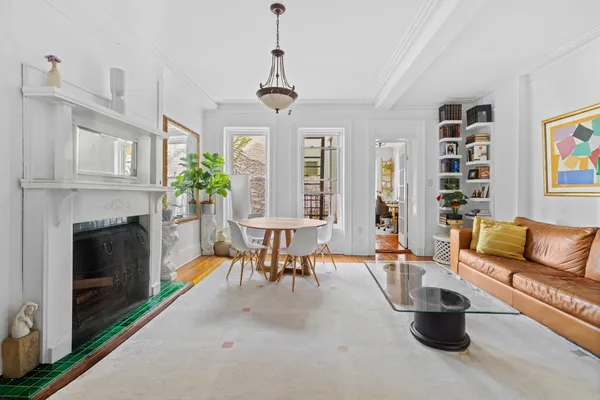 a living room with furniture a fireplace and a chandelier