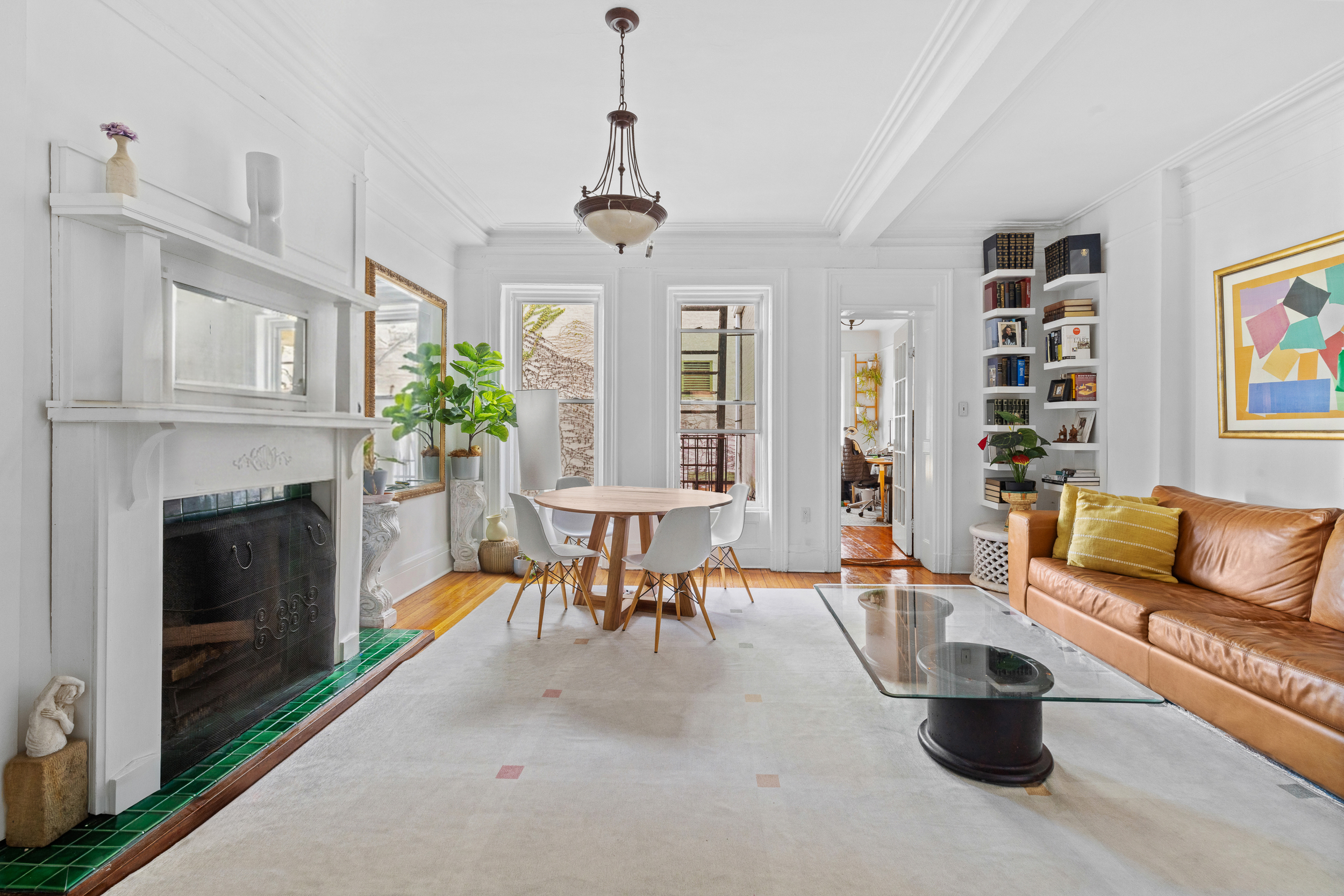 a living room with furniture a fireplace and a chandelier