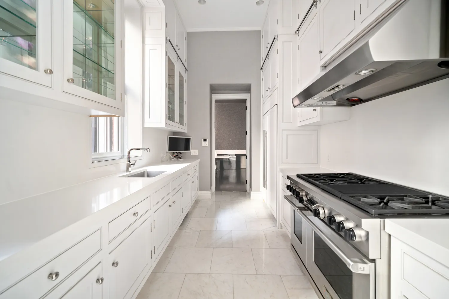 a bathroom with a double vanity sink a mirror a bathtub and next to a window