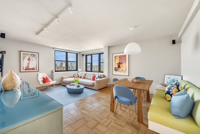 61 Jane Street, Unit 15A Manhattan, NY 10014 - Photo 1 of 10 a living room with lots of furniture and a wooden floor