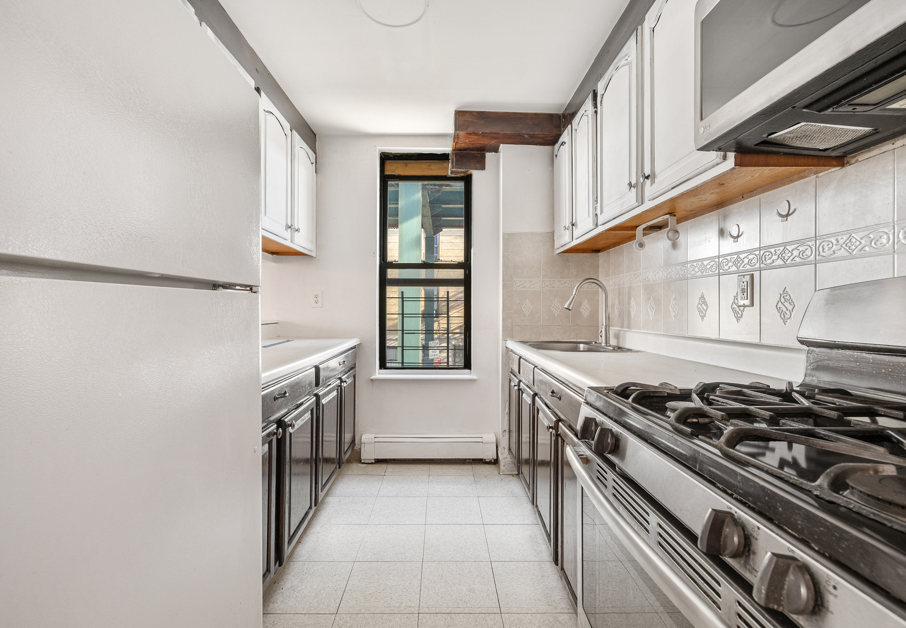 106 Crescent Street Brooklyn, NY 11208 - Photo 10 of 18 a kitchen with a stove and a sink