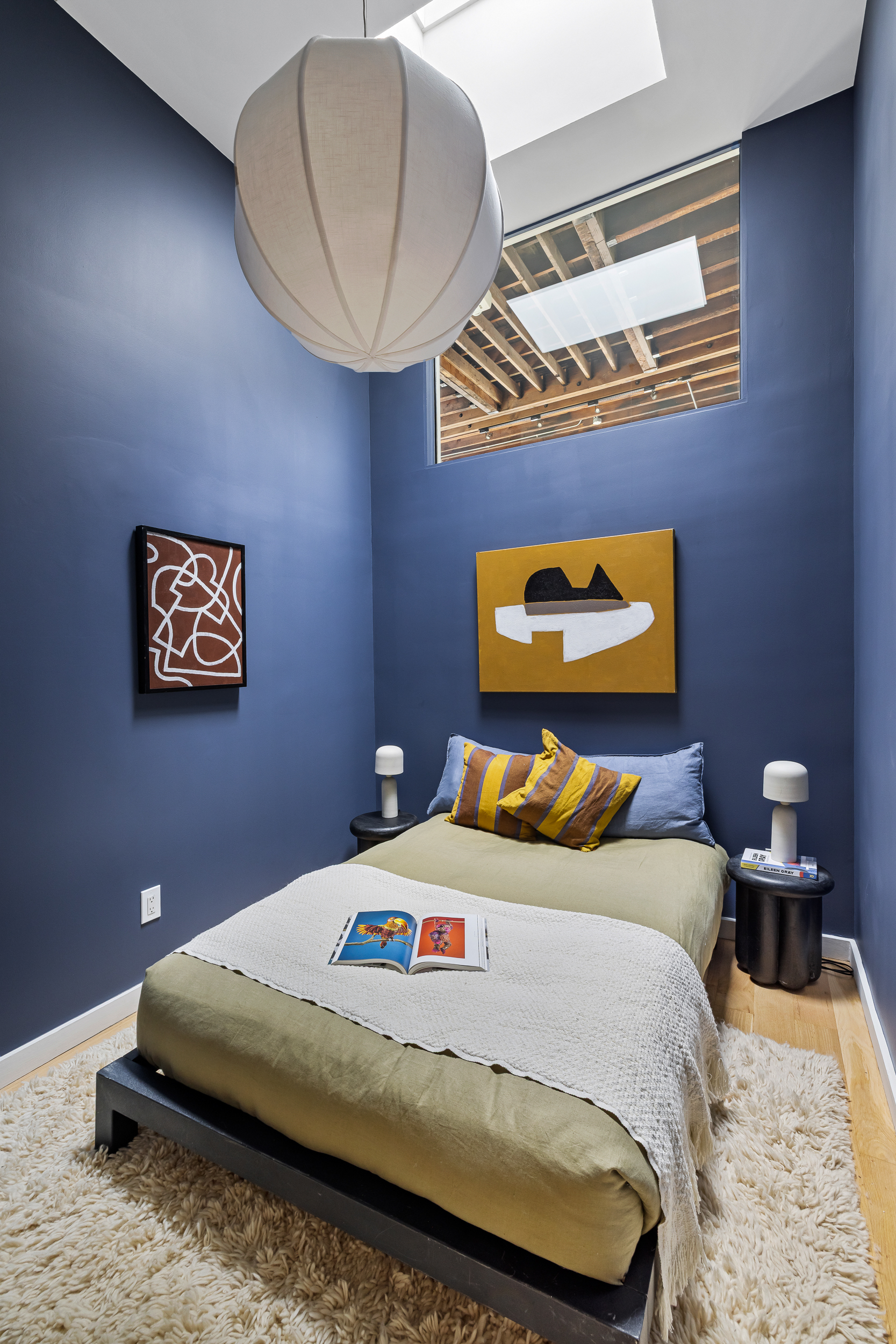 325 Bowery, Unit PH Manhattan, NY 10003 - Photo 14 of 17 a bedroom with a bed and a painting on the wall