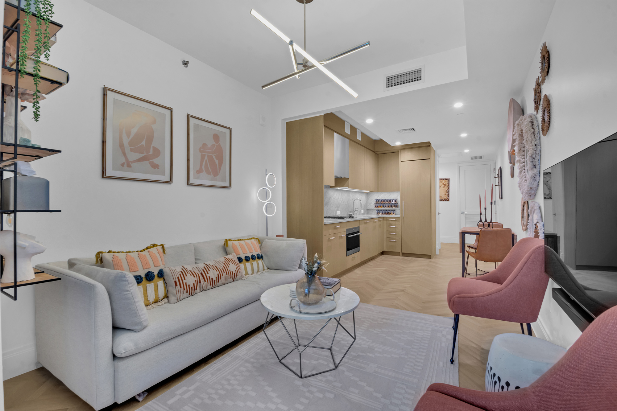 300 West 122nd Street, Unit 6R Manhattan, NY 10027 - Photo 3 of 23 a living room with furniture kitchen view and a chandelier