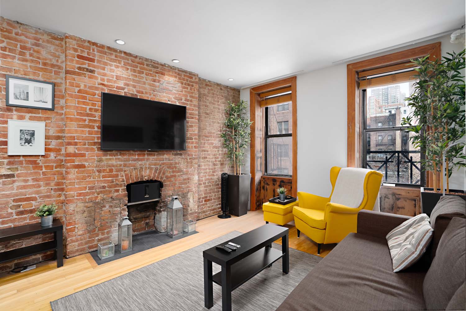 218 East 82nd Street, Unit 4FW Manhattan, NY 10028 - Photo 2 of 9 a living room with fireplace furniture and a flat screen tv
