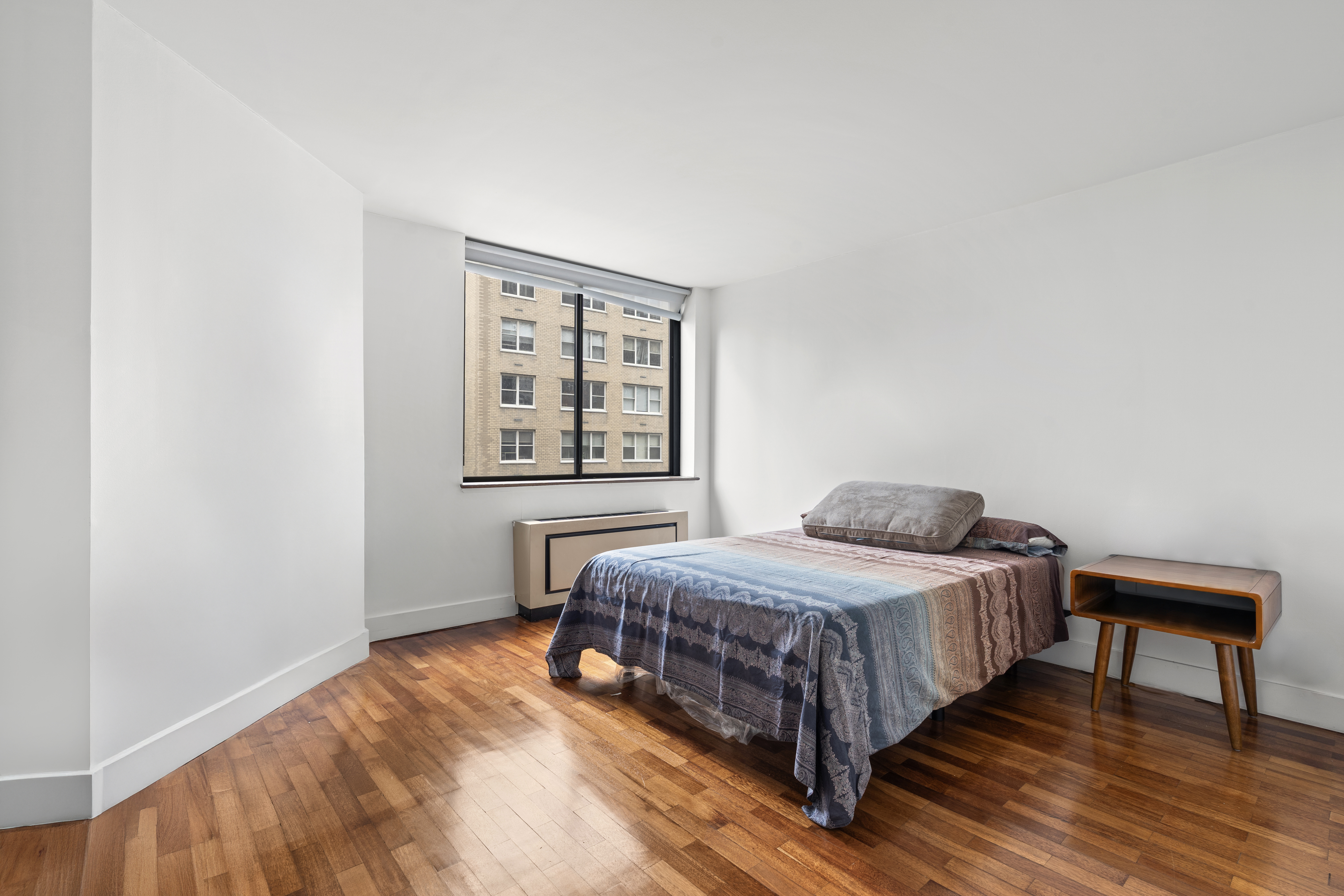 330 East 75th Street, Unit 4K Manhattan, NY 10021 - Photo 7 of 9 a bedroom with a bed and a window
