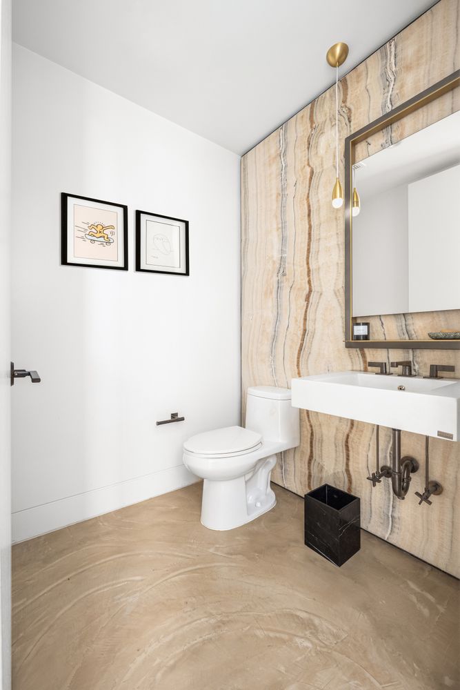 a bathroom with a sink a toilet and a large mirror