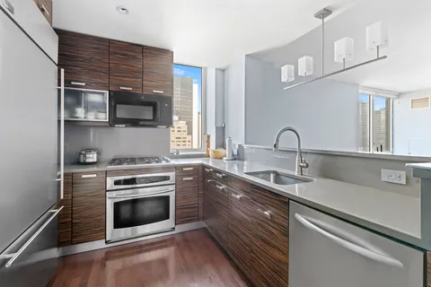 a kitchen with stainless steel appliances a stove sink and cabinets