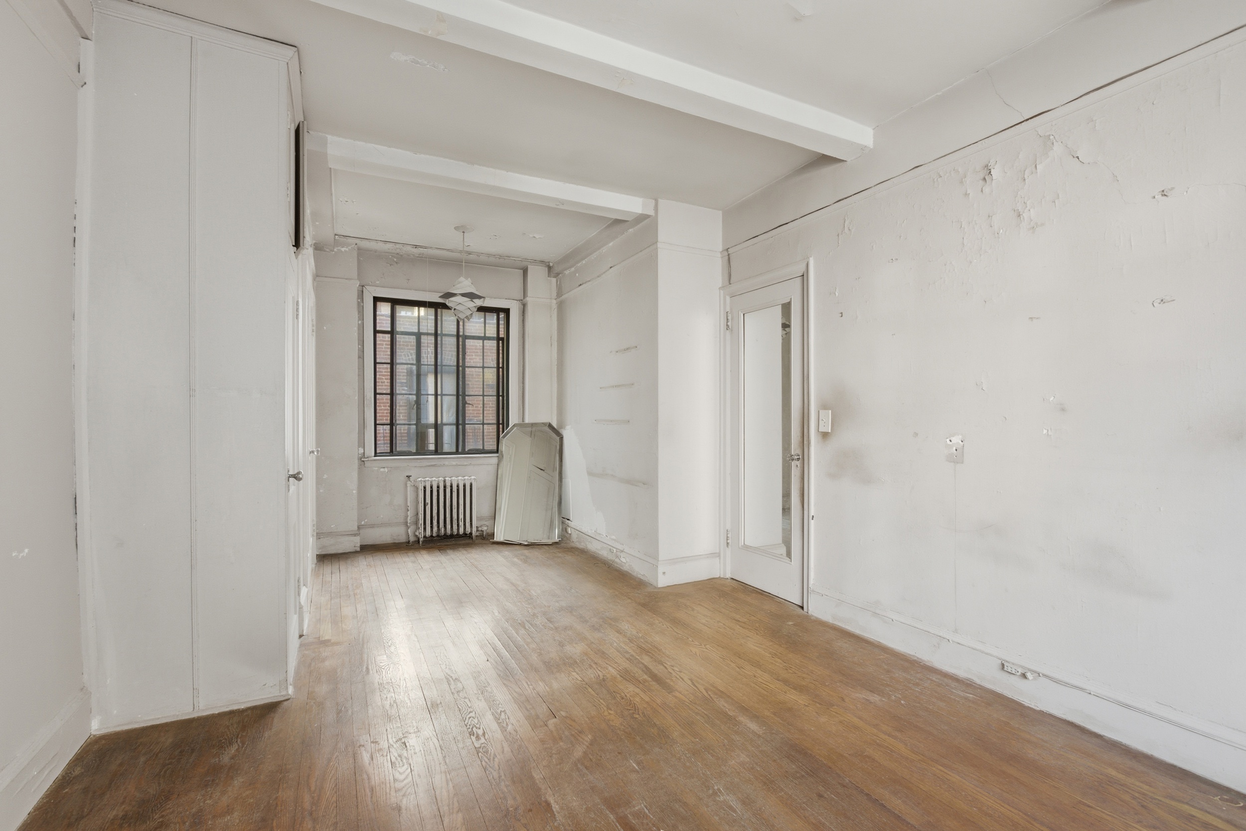 210 West 78th Street, Unit 8C Manhattan, NY 10024 - Photo 16 of 21 an empty room with wooden floor and windows