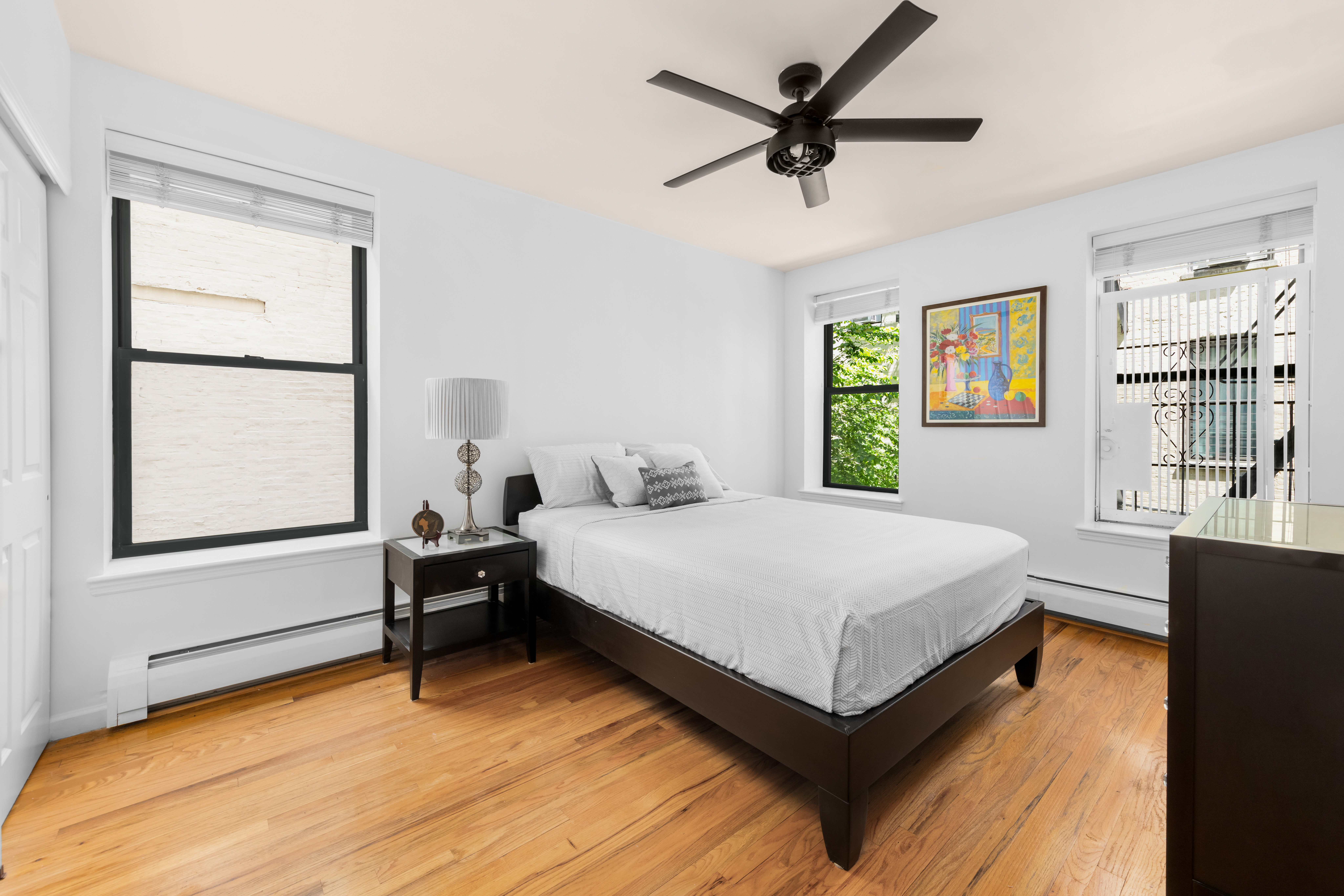 231 West 148th Street, Unit 2L Manhattan, NY 10039 - Photo 5 of 15 a bedroom with a bed and a window