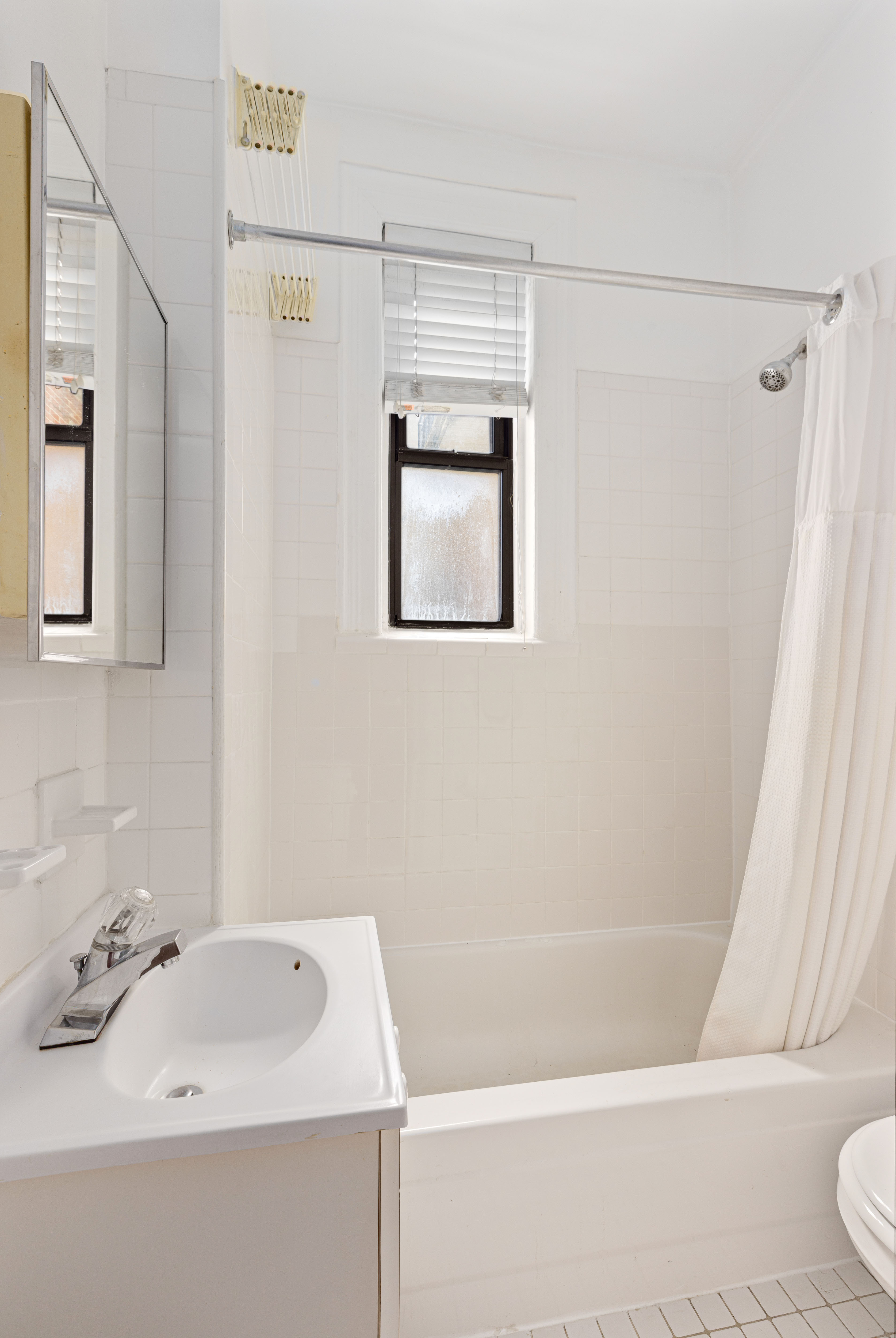 199 Prince Street, Unit 17 Manhattan, NY 10012 - Photo 5 of 6 a bathroom with a sink a window and a shower