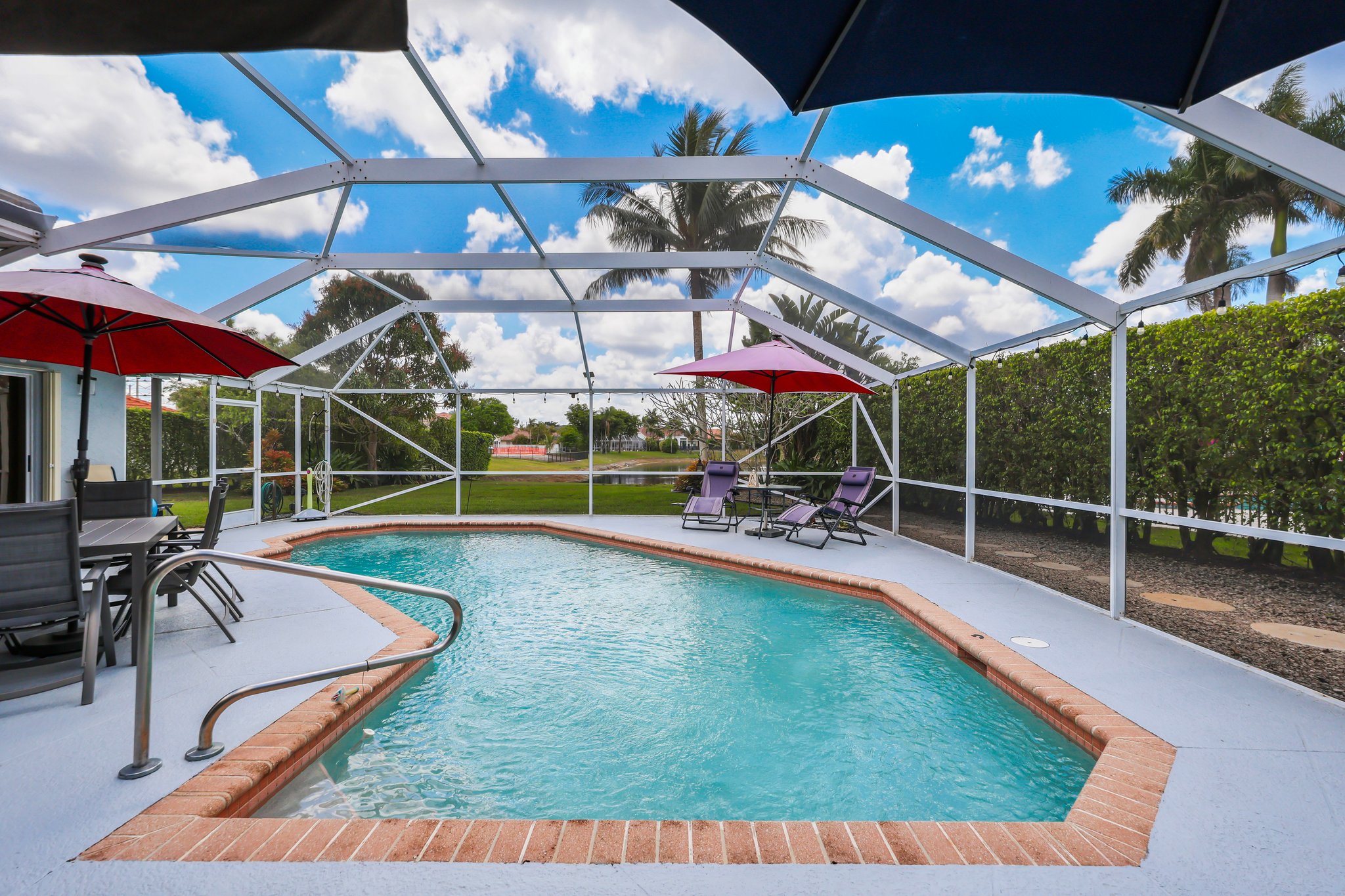 20317 Hacienda Court Boca Raton, FL 33498 - Photo 31 of 100 a view of a backyard with a patio and a yard