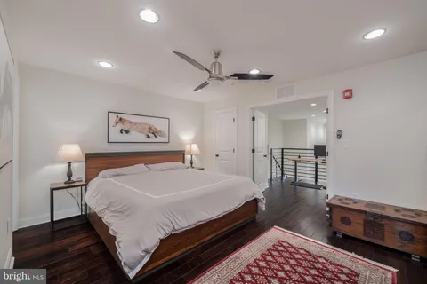 a bedroom with a bed a table and painting