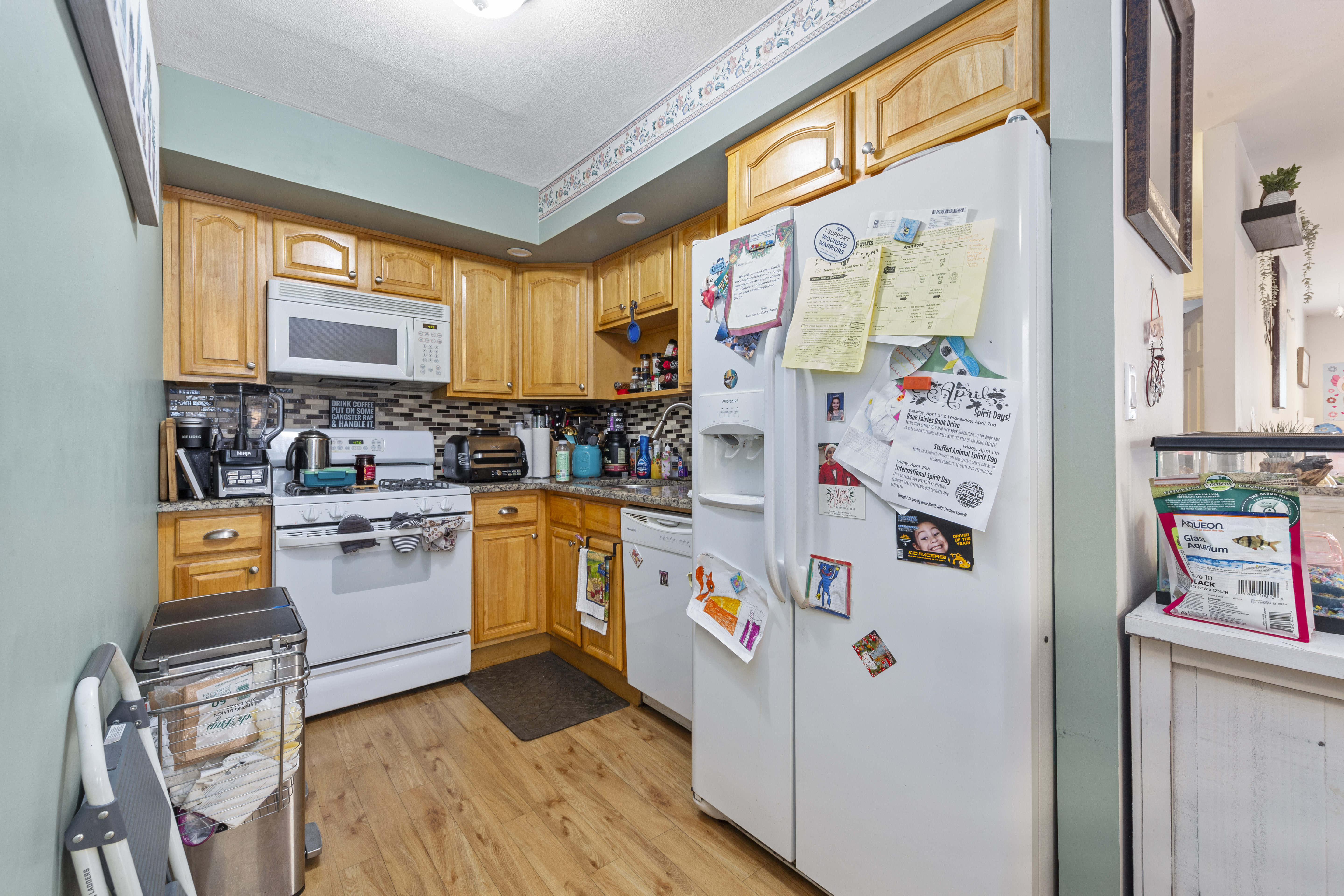 240-47 68th Avenue Queens, NY 11362 - Photo 19 of 39 a kitchen with refrigerator and window