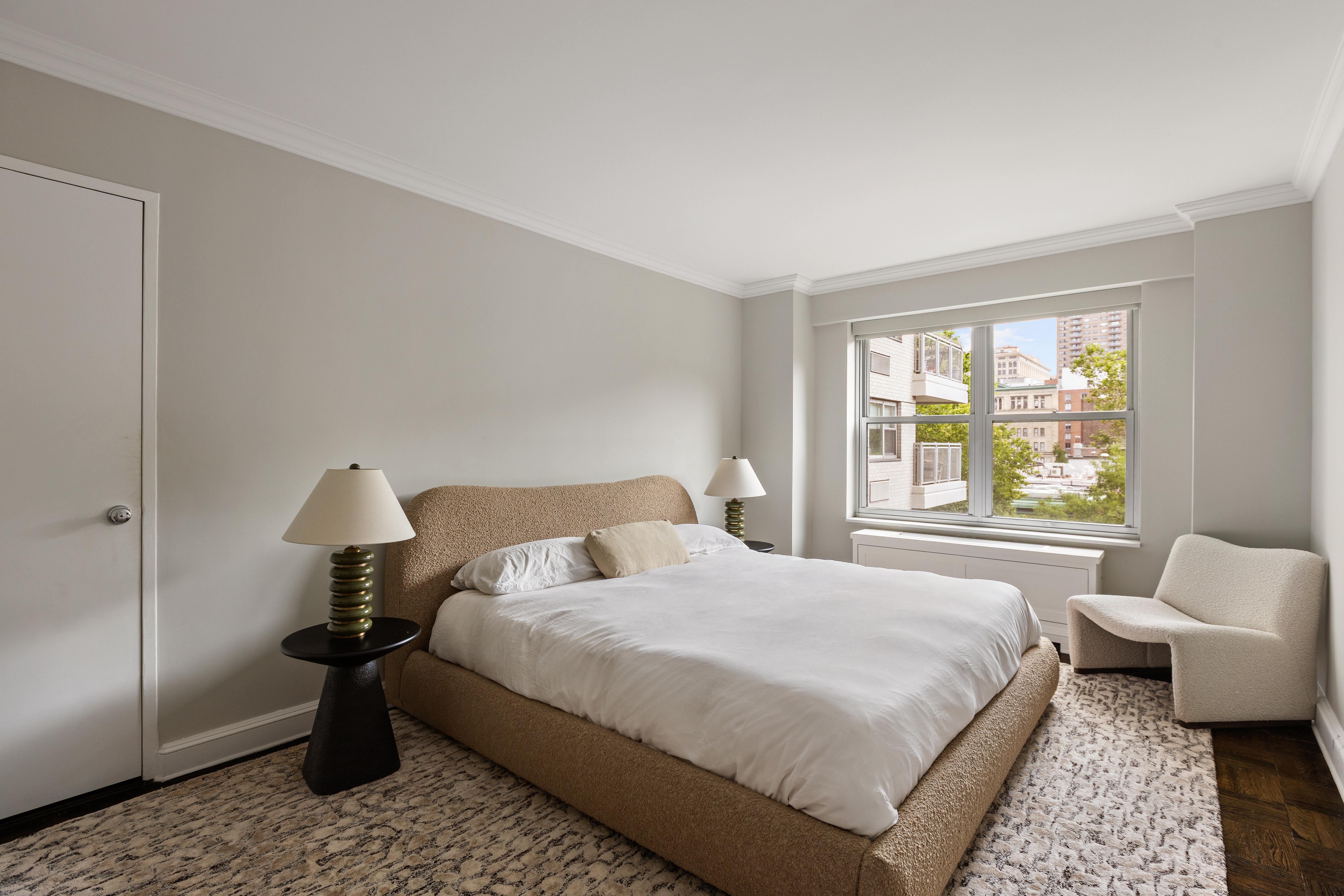 2 5th Avenue, Unit 5F Manhattan, NY 10011 - Photo 4 of 9 a bedroom with a bed lamp and window