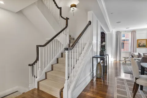 a view of entryway and hall with wooden floor