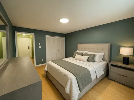a bedroom with a bed and a lamp