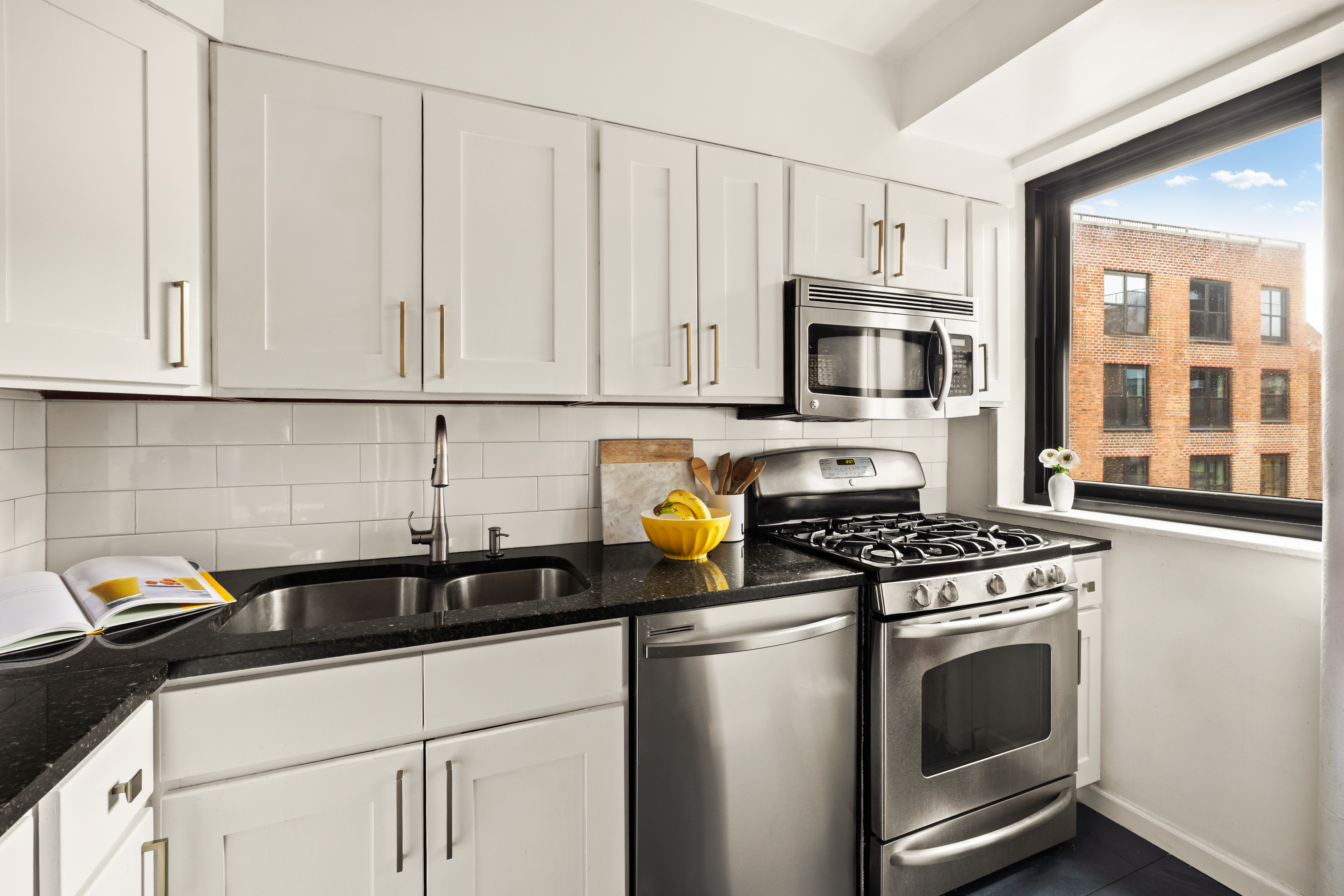 205 Clinton Avenue, Unit 12G Brooklyn, NY 11205 - Photo 4 of 8 a kitchen with granite countertop a stove sink and cabinets