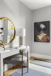 a view of a hallway with paintings on the wall